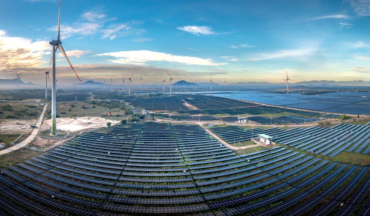 Wind turbines and solar panels across a utility landscape