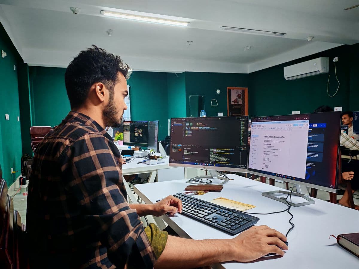 Software developer deploying code in a modern office